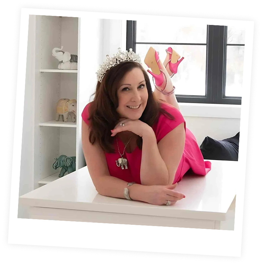 Woman in pink dress with a crown.